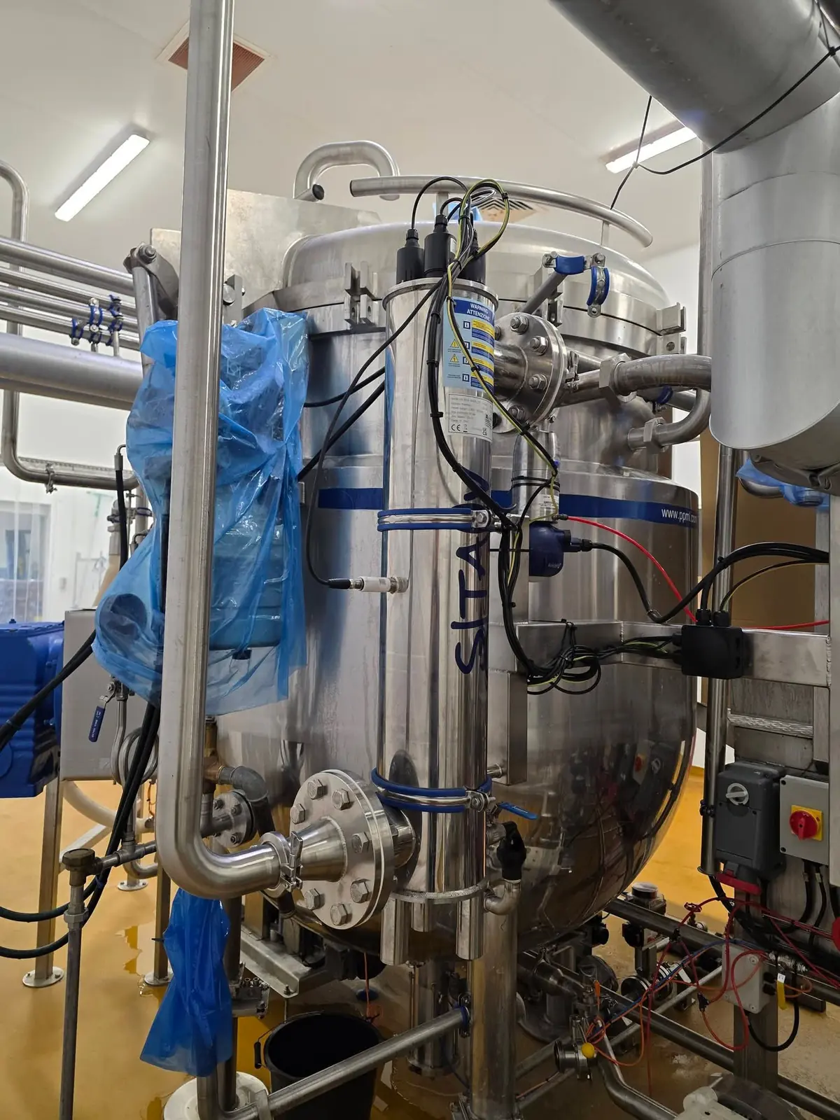 UV treatment unit mounted on a stainless steel vessel with hygienic pipework