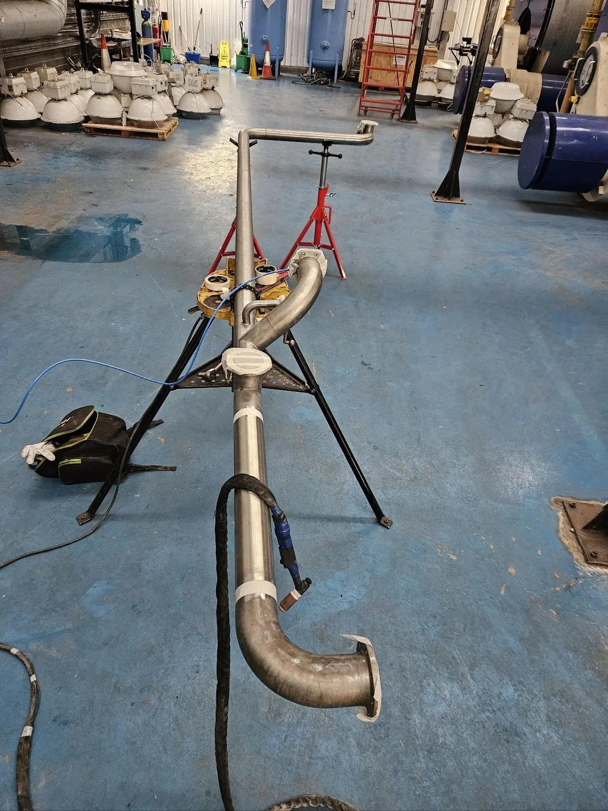 Stainless steel pipe run on stands in the workshop
